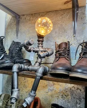 Lampe en tuyaux et bottes de cuir