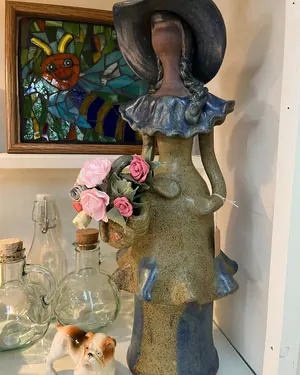 Ceramic figurine and glass bottles