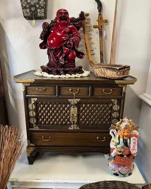 Asian cabinet with a red laughing Buddha