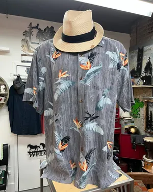Hawaiian print shirt with a straw hat